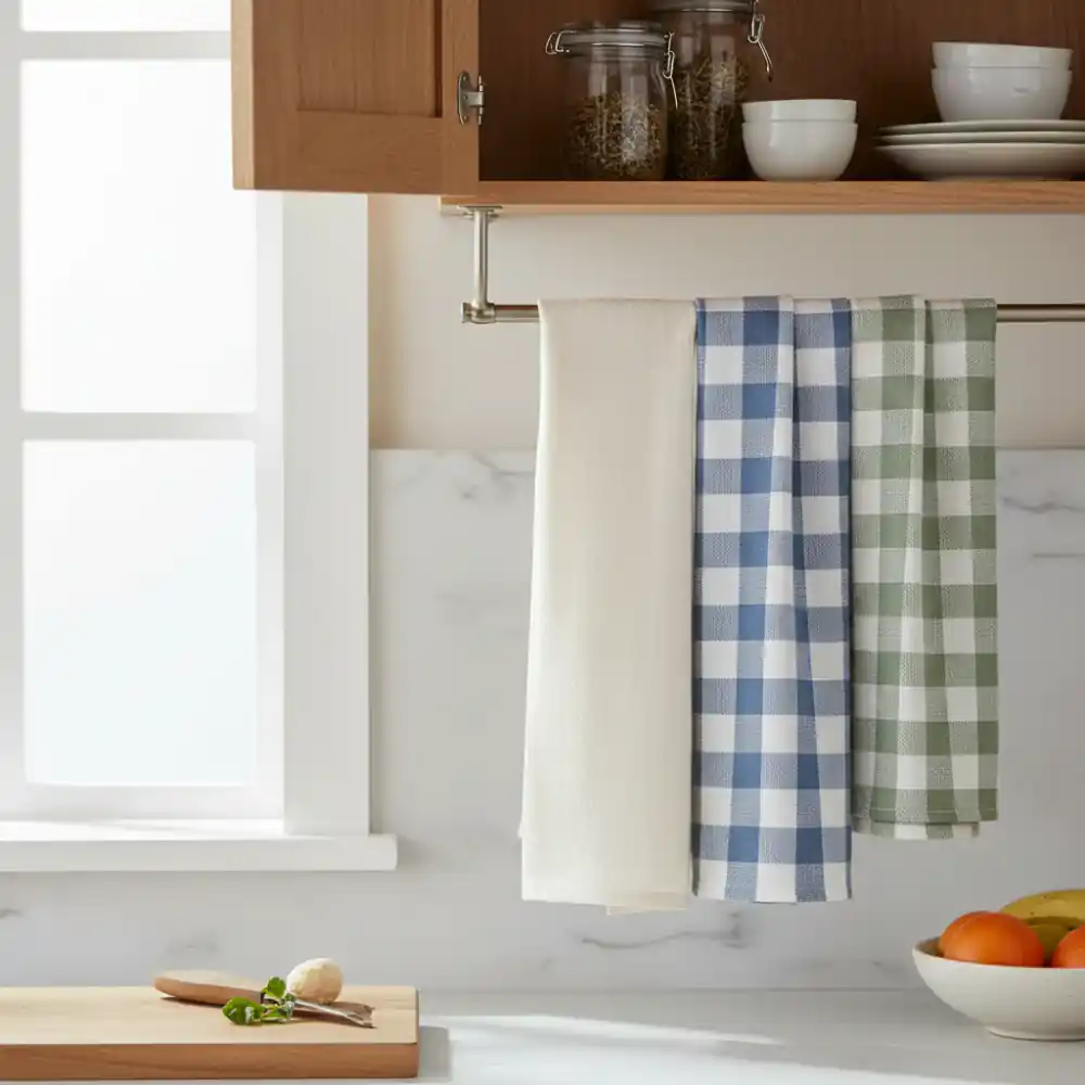 Set of neutral kitchen towels hanging on hooks